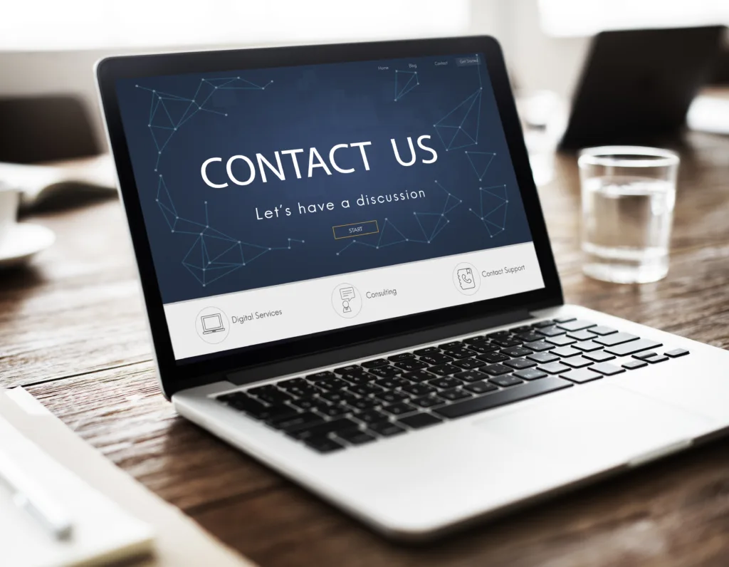 A laptop with screen that has contact us page