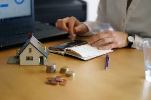 Marrakech property tax guide showing house model, calculator, and financial planning
