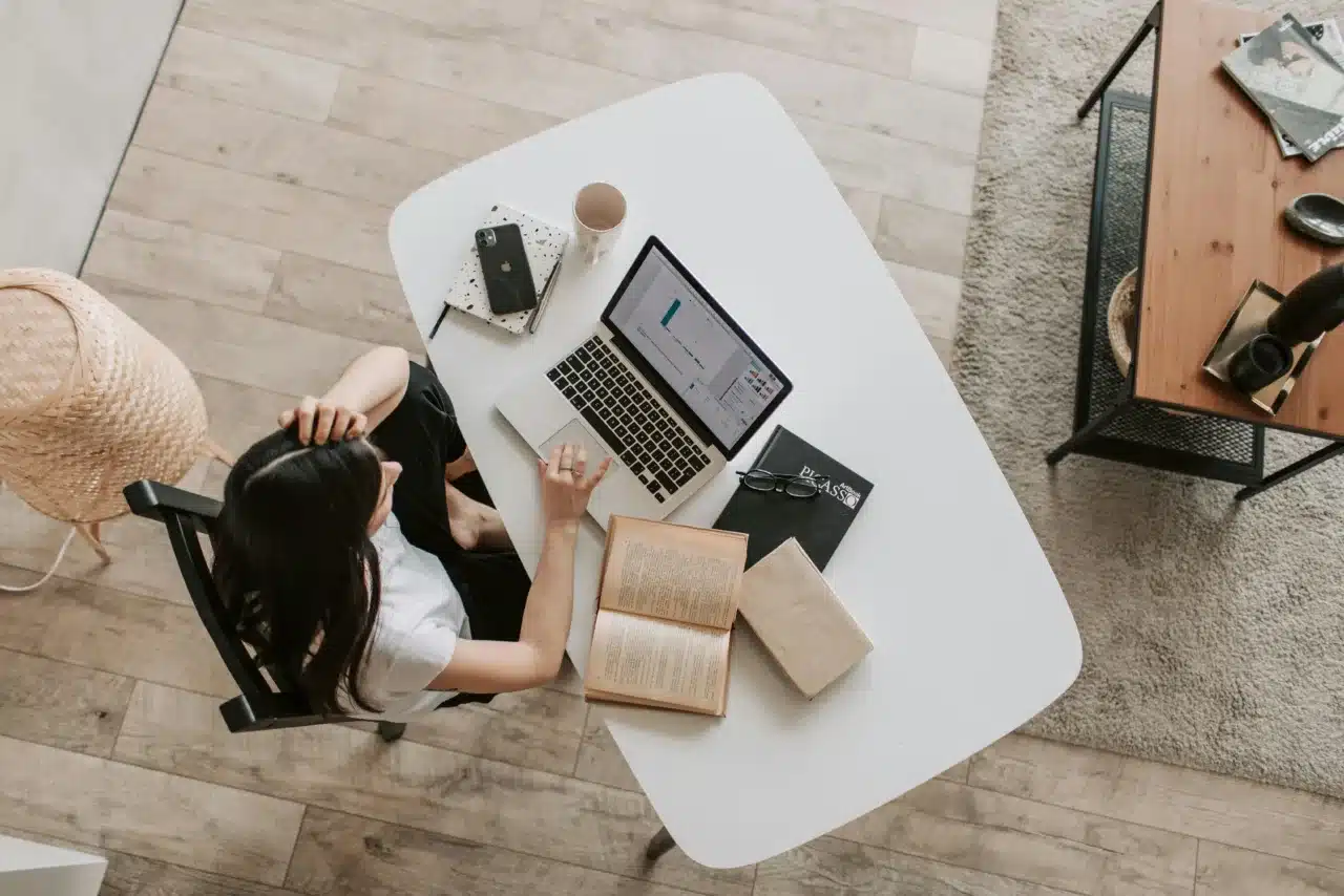 Young woman using a laptop in a modern workspace, symbolising flexible study areas for student accommodation investment opportunities in Morocco.